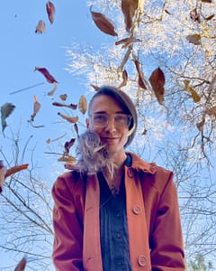 Blair posing with falling leaves