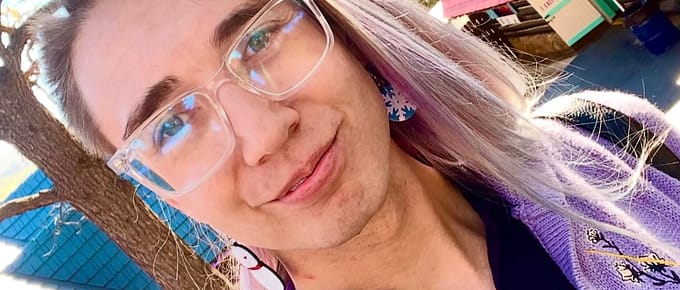 Blair wearing purple cardigan