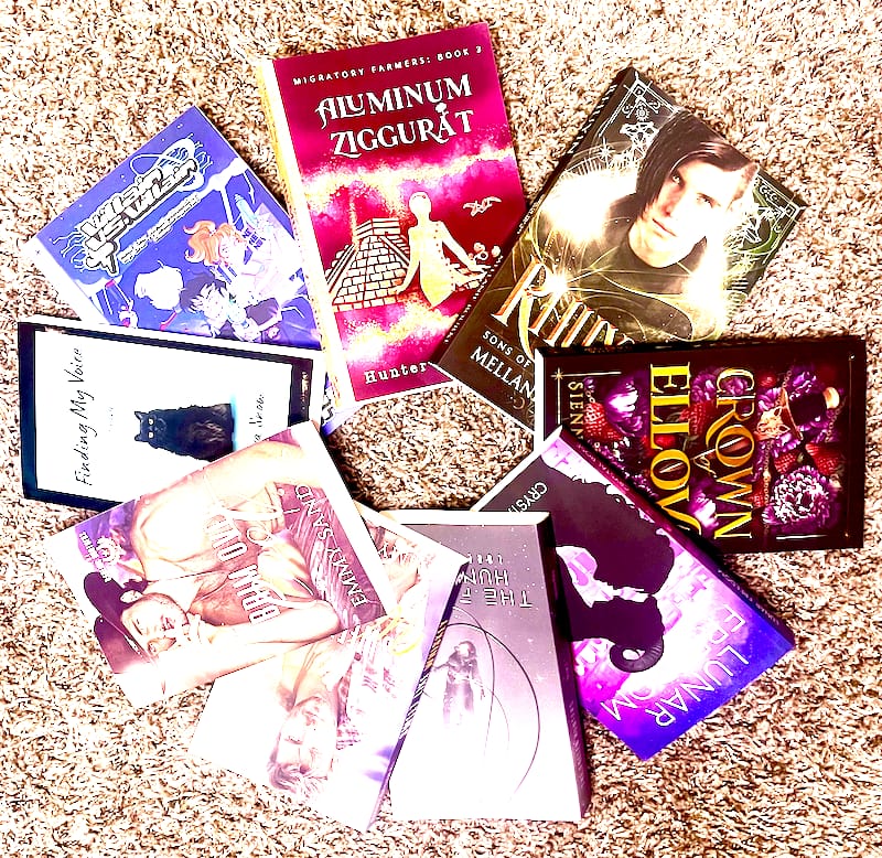 Copies of all the books Blair has sensitivity read laid out in a circular wheel.